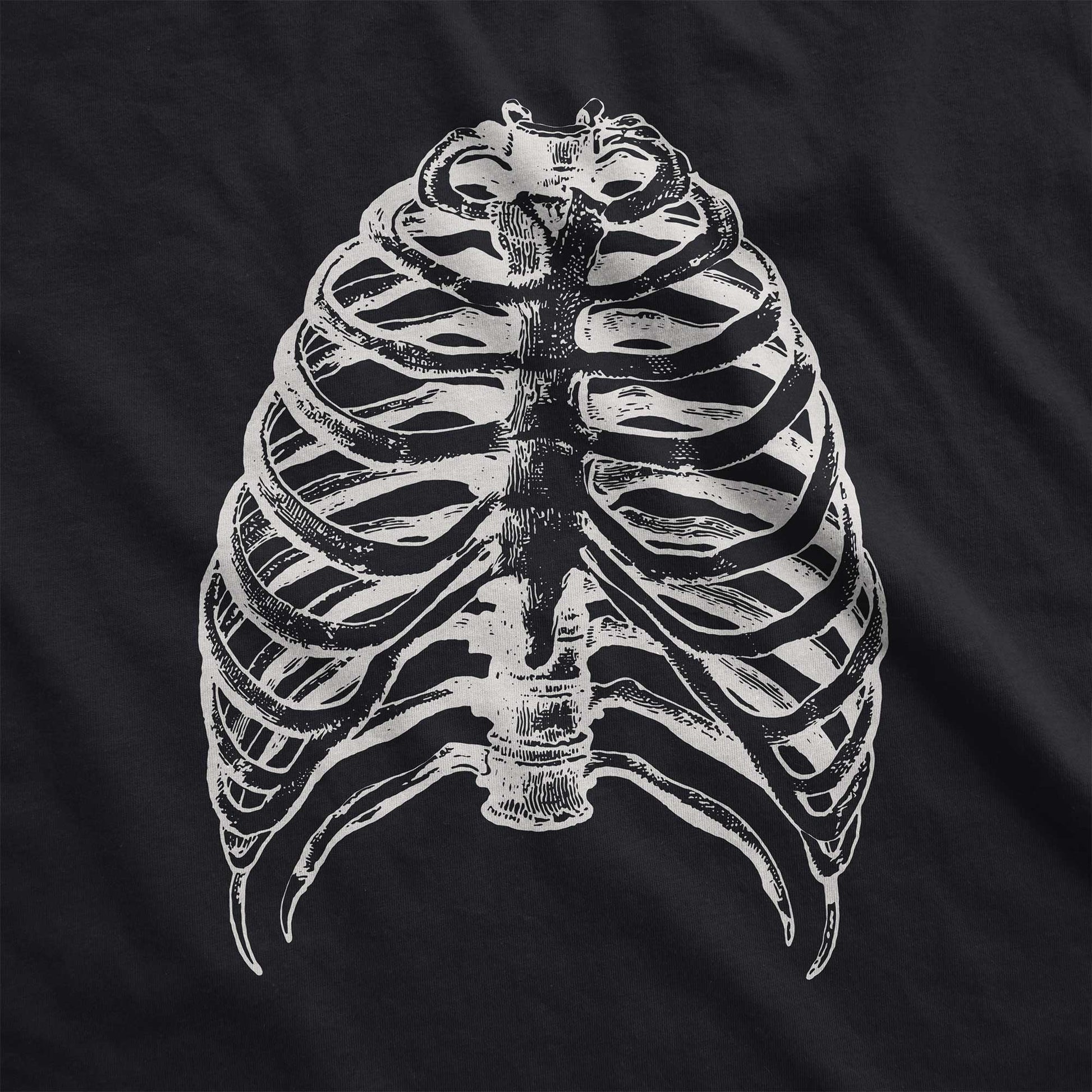 A vintage black Bella Canvas swatch featuring a vintage illustration of a skeletons rib cage.
