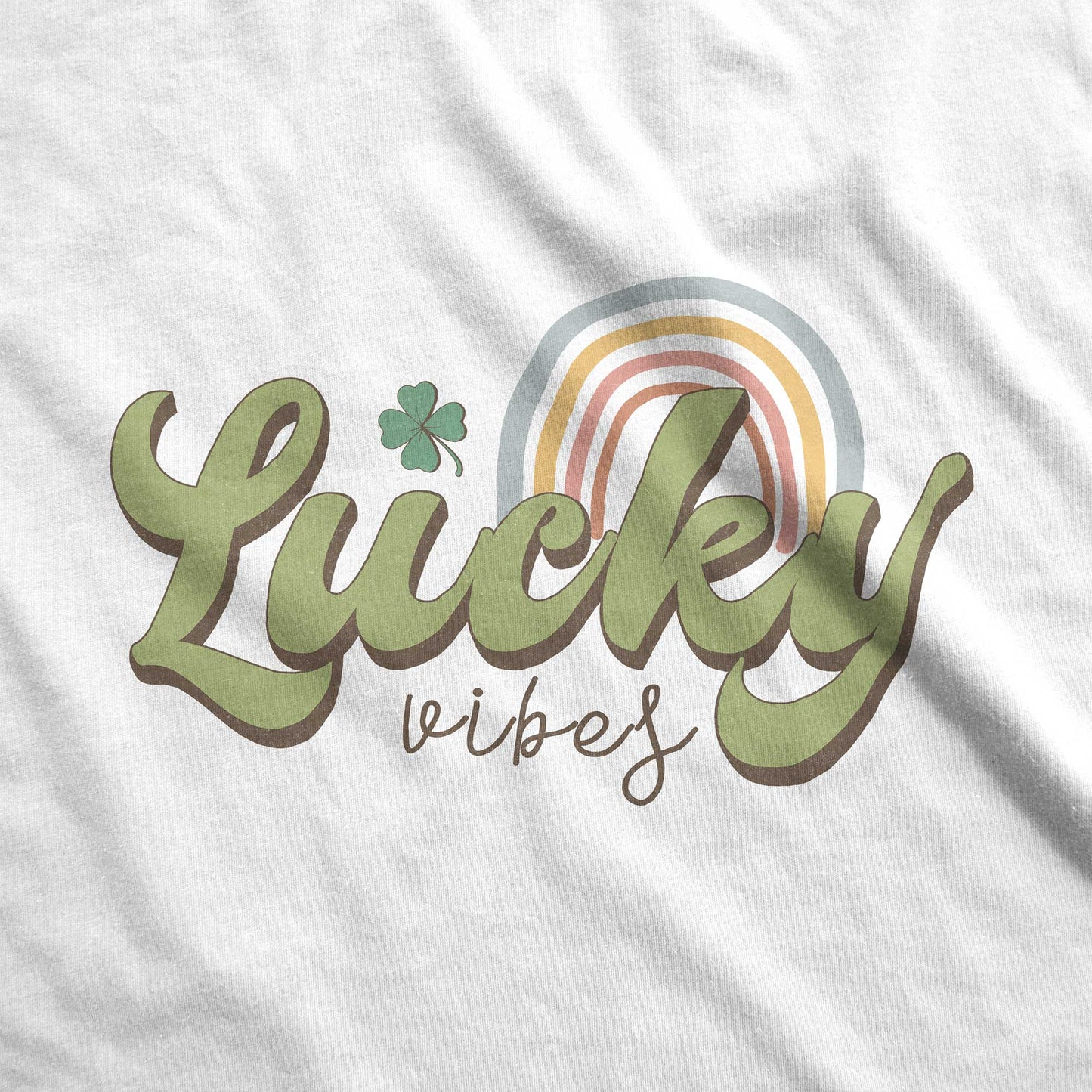 A white fabric swatch featuring the words lucky vibes and a rainbow.