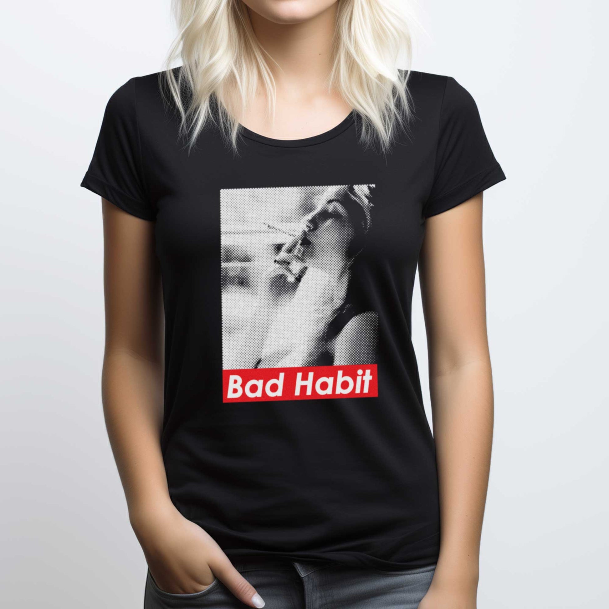 A woman wearing a black District 7501 flex scoop neck t-shirt featuring a grainy photograph of a woman smoking with the words bad habit below.