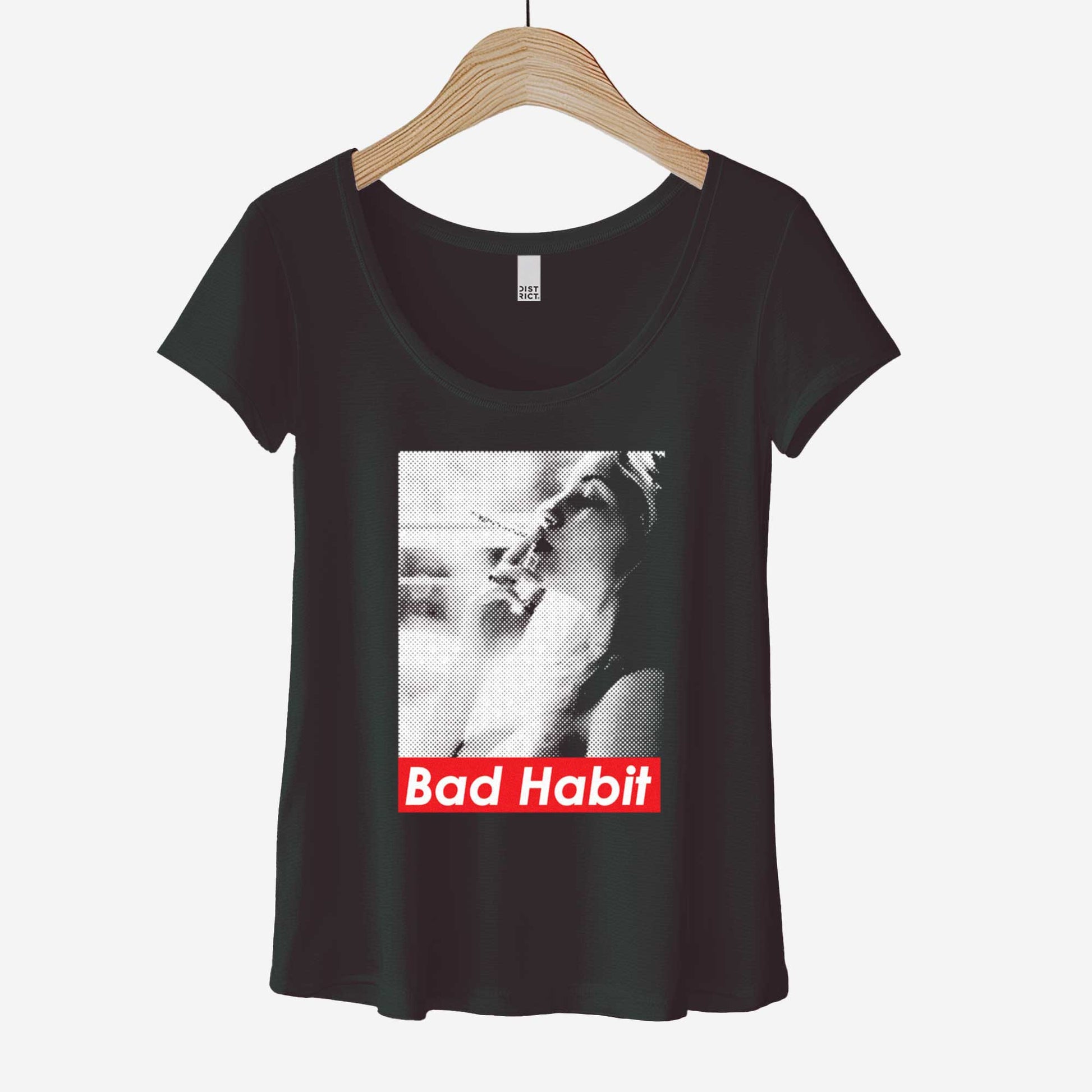 A hanging black District 7501 t-shirt featuring a grainy photograph of a woman smoking with the words bad habit below.