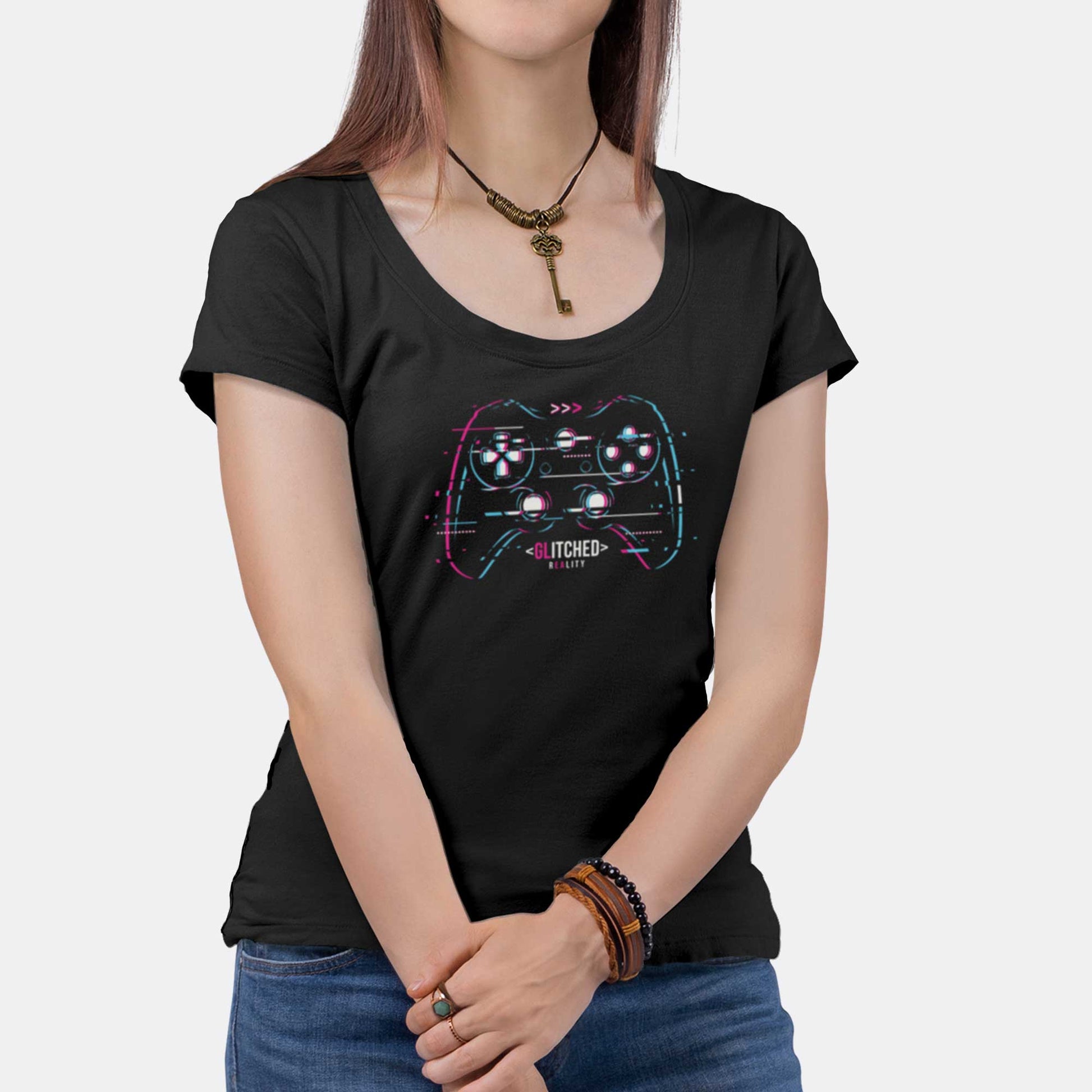 A woman wearing a black District 7501 scoop neck t-shirt featuring a glitchy video game controller in neon colors with the words glitched reality.