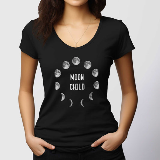 A woman wearing a black District 7501 scoop neck t-shirt with the phases of the moon in a circle and the words moon child in the center.