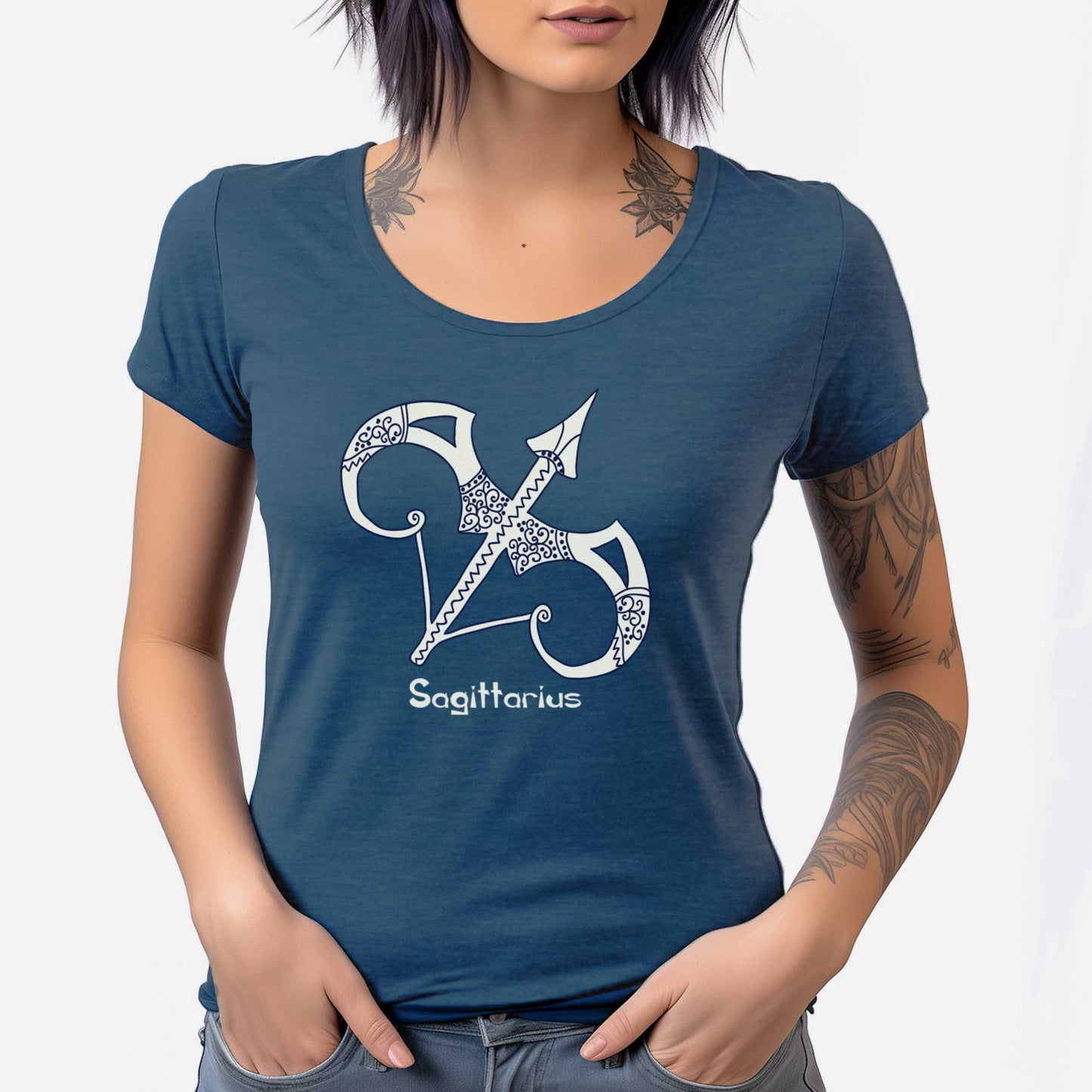 A woman wearing a heathered neptune District 7501 scoop neck t-shirt featuring the zodiac symbol of Sagittarius, the bow and arrow, in a Mediterranean style.