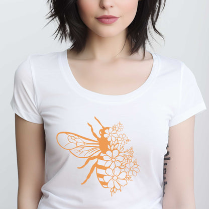 A woman wearing a white District t-shirt featuring a bee half covered in flowers.