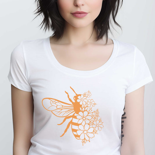 A woman wearing a white District t-shirt featuring a bee half covered in flowers.