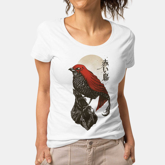 A woman wearing a white District scoop neck t-shirt featuring a detailed illustration of a red bird.