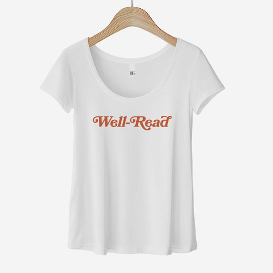 A white District 7501 scoop neck t-shirt featuring the words well-read in clay colored font.