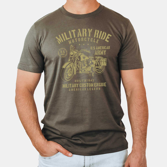 A man wearing an army green Bella Canvas t-shirt featuring a vintage American army motorcycle and the words military ride motorcycle.