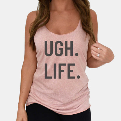 A woman wearing a desert pink Next Level racerback tank featuring the words ugh life.
