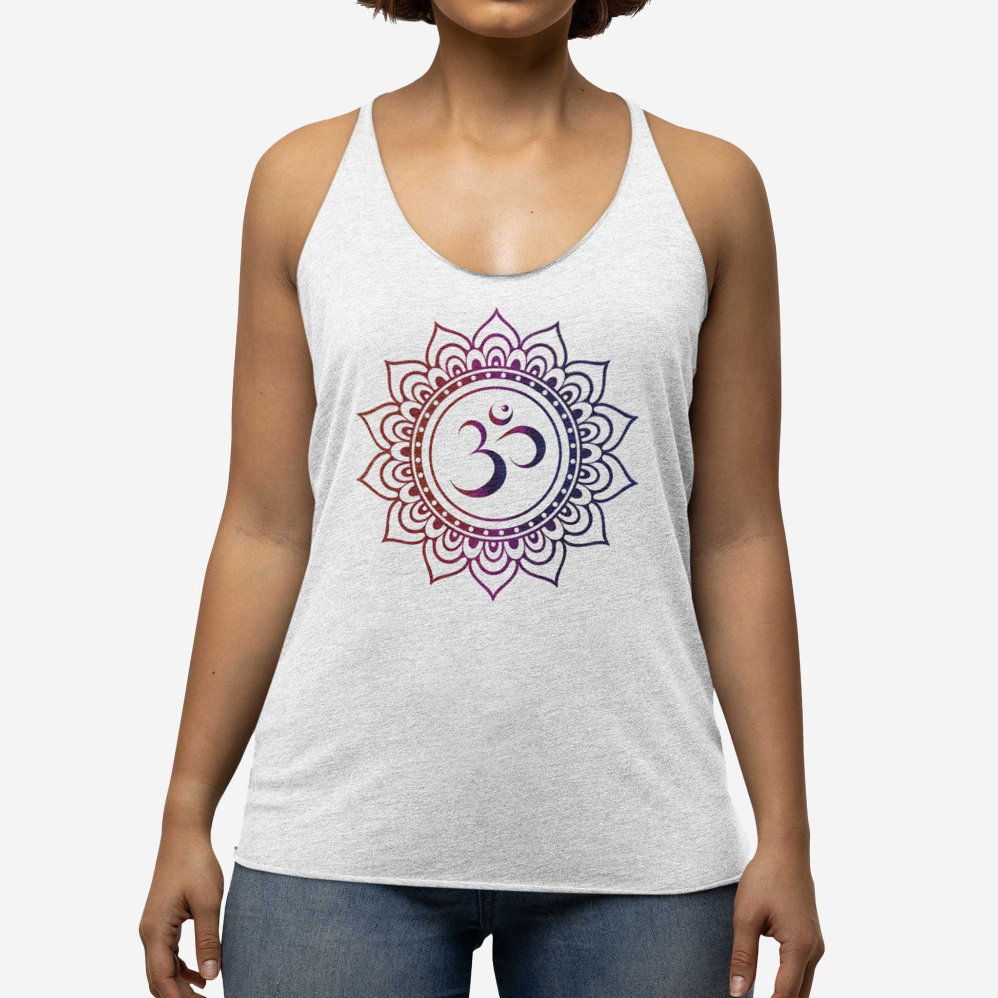 A woman wearing a heather white Next Level triblend racerback tank top featuring an om symbol surrounded by a mandala.