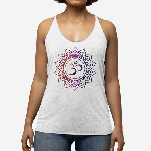 A woman wearing a heather white Next Level triblend racerback tank top featuring an om symbol surrounded by a mandala.