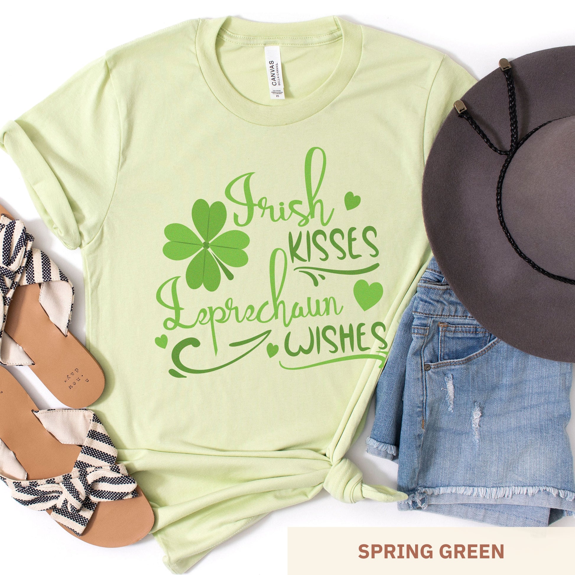 A spring green Bella Canvas t-shirt with a shamrock and the words irish kisses leprachaun wishes
