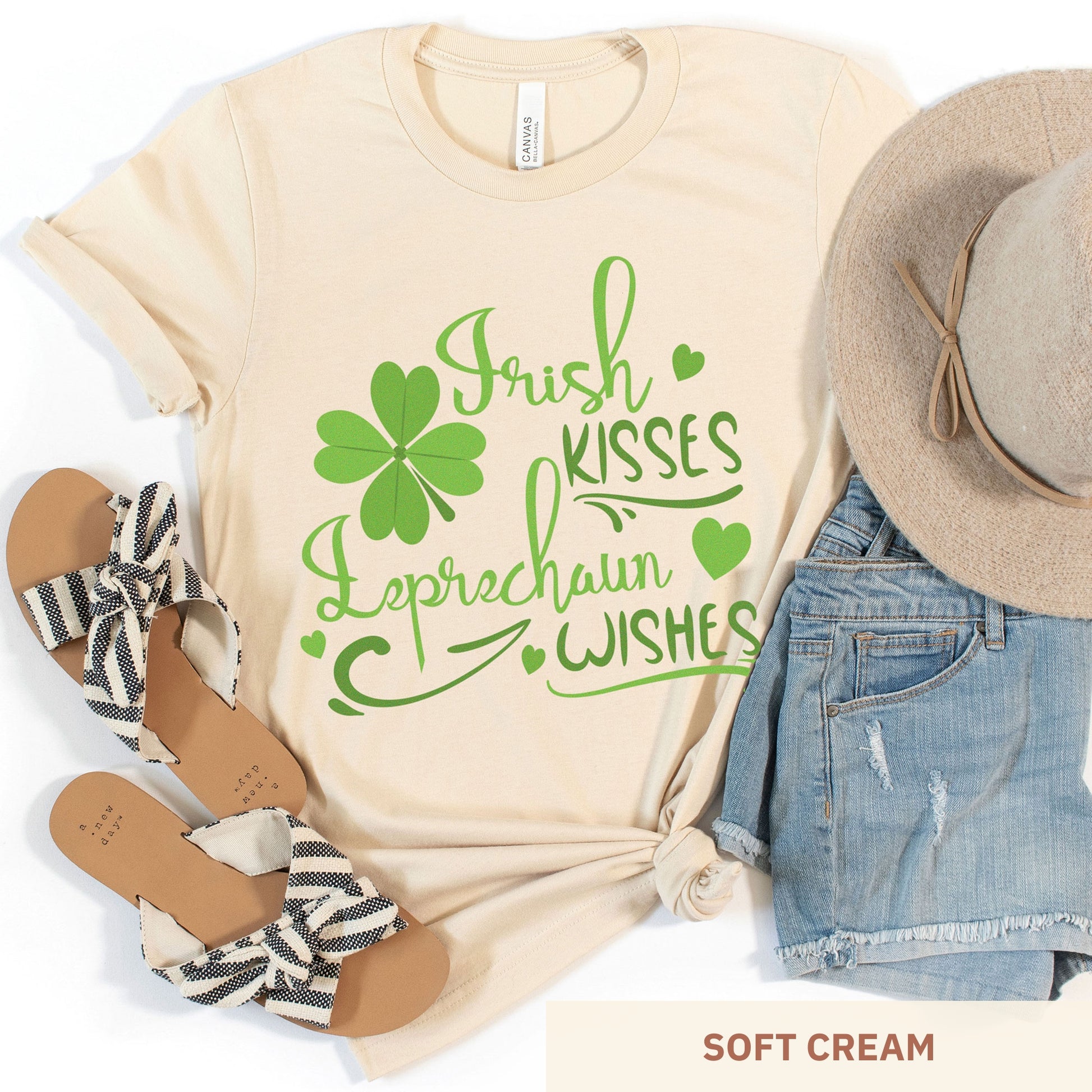 A soft cream Bella Canvas t-shirt with a shamrock and the words irish kisses leprachaun wishes