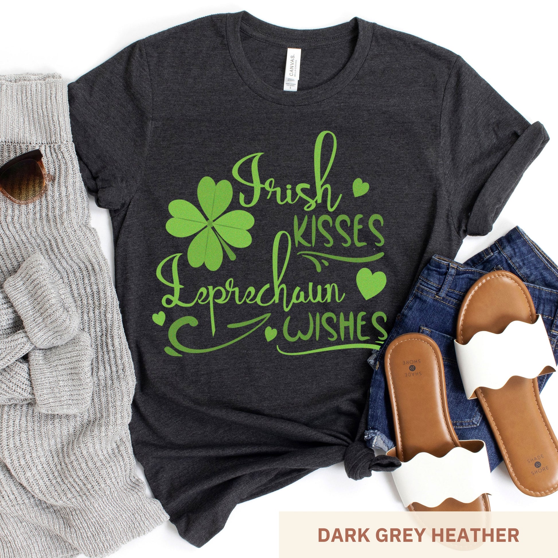 A dark grey heather Bella Canvas t-shirt with a shamrock and the words irish kisses leprachaun wishes