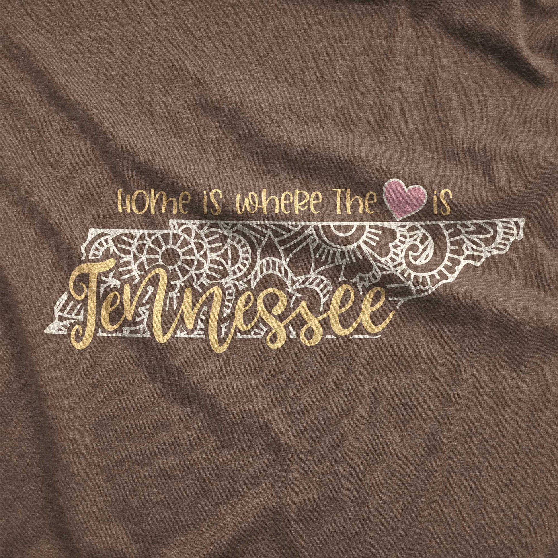 A heather brown Bella Canvas swatch featuring a mandala in the shape of Tennessee with the words home is where the heart is.