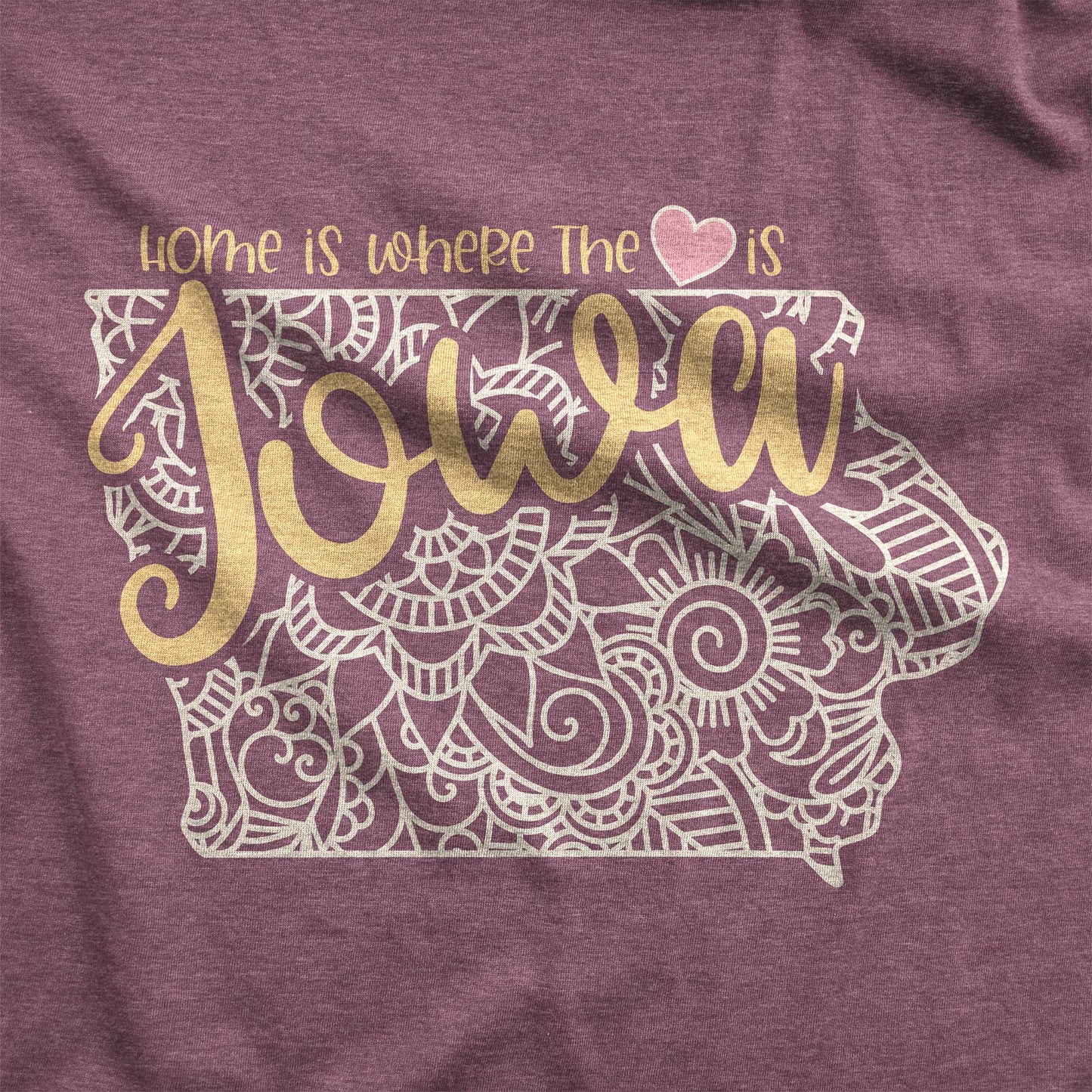 A heather maroon Bella Canvas swatch featuring a mandala in the shape of Iowa with the words home is where the heart is.
