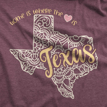 A heather maroon Bella Canvas swatch featuring a mandala in the shape of Texas with the words home is where the heart is.