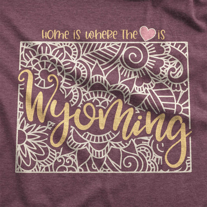 A heather maroon Bella Canvas swatch featuring a mandala in the shape of Wyoming with the words home is where the heart is.