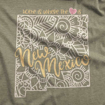 A heather olive Bella Canvas swatch featuring a mandala in the shape of New Mexico with the words home is where the heart is.