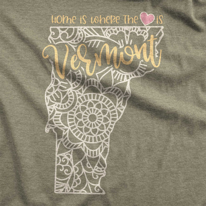 A heather olive Bella Canvas swatch featuring a mandala in the shape of Vermont with the words home is where the heart is.